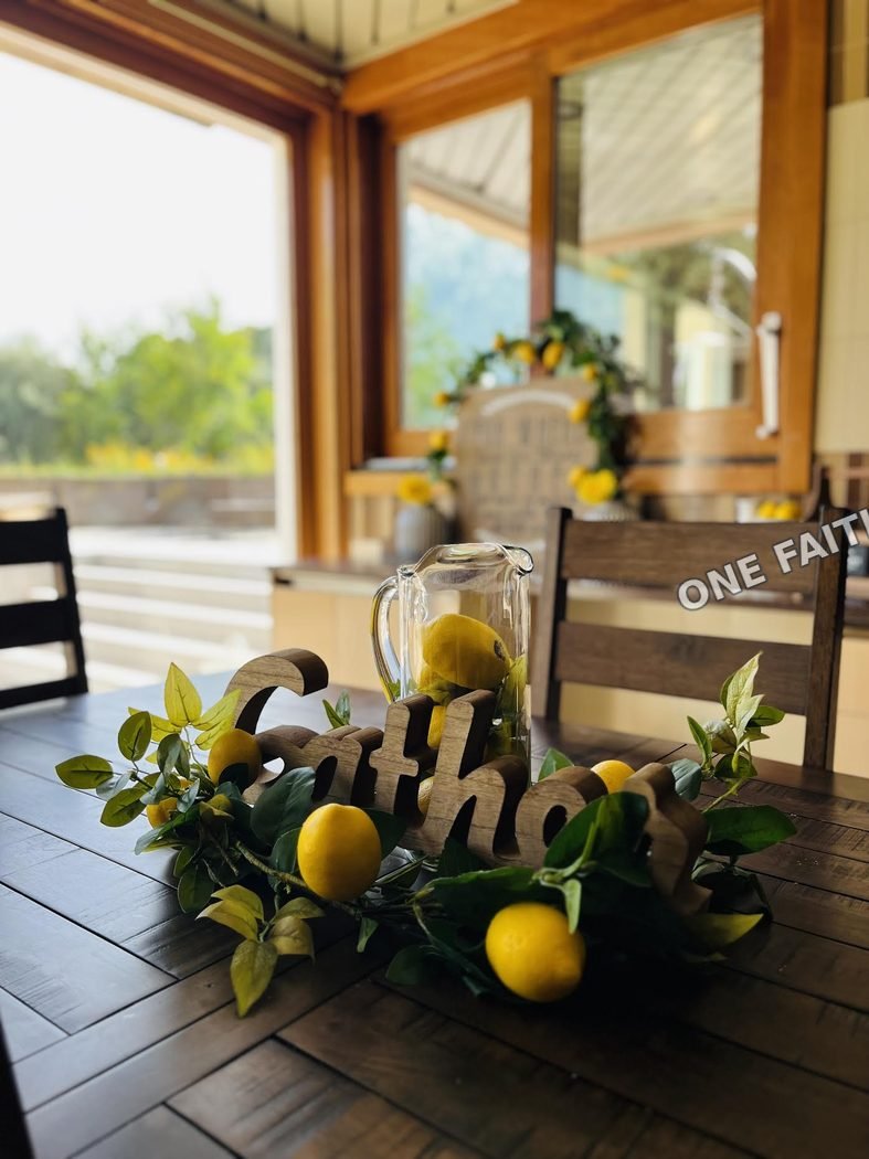 Lemons arranged on a table by a window.