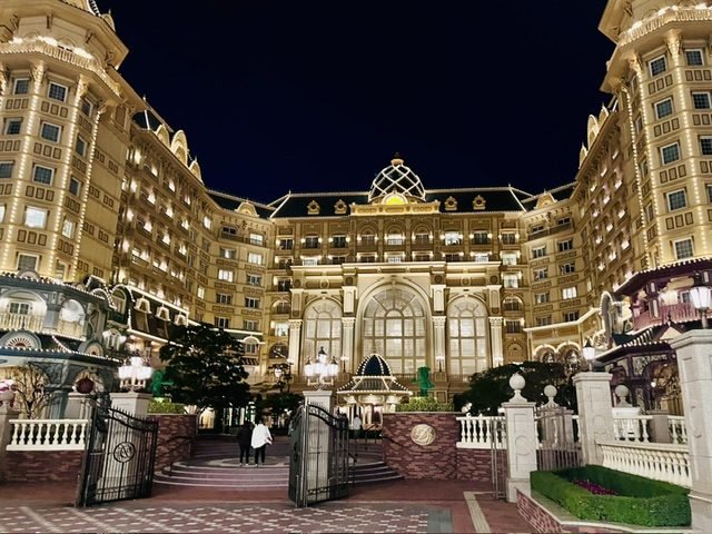 A grand hotel building illuminated at night.